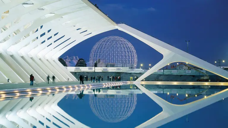 The futuristic white sculptural buildings of Valencia's City of Arts and Sciences reflected in surrounding turquoise pools