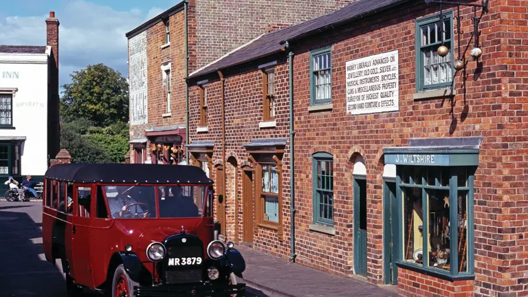 Recreated Victorian industrial street with period shops, gas lamps and tramlines at the open-air Black Country Living Museum