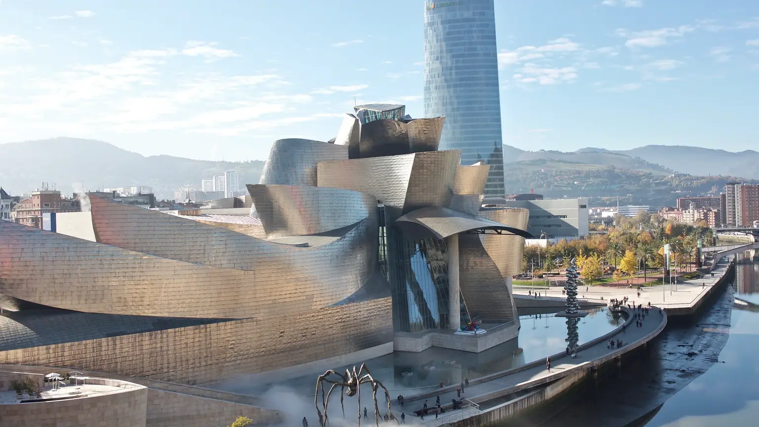 The shimmering titanium-clad curves of Frank Gehry's Guggenheim Museum in Bilbao, beside the Nervión river