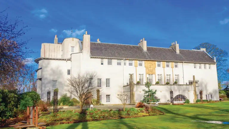 The white roughcast walls and golden frieze of the House for an Art Lover in Bellahouston Park, Glasgow, built between 1989 and 1996 to Charles Rennie Mackintosh's 1901 competition design