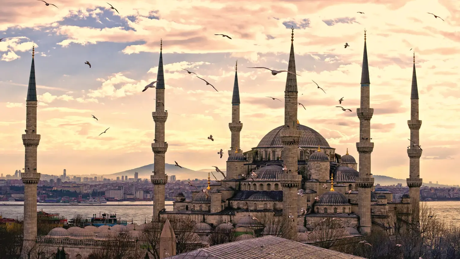 The Blue Mosque (Sultan Ahmed Mosque) at dusk, its cascade of domes and six slender minarets silhouetted against the sky