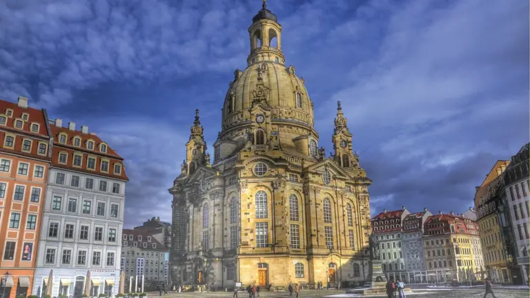 The domed Baroque Frauenkirche rising above Dresden's Neumarkt square, ringed by tall pastel-fronted townhouses