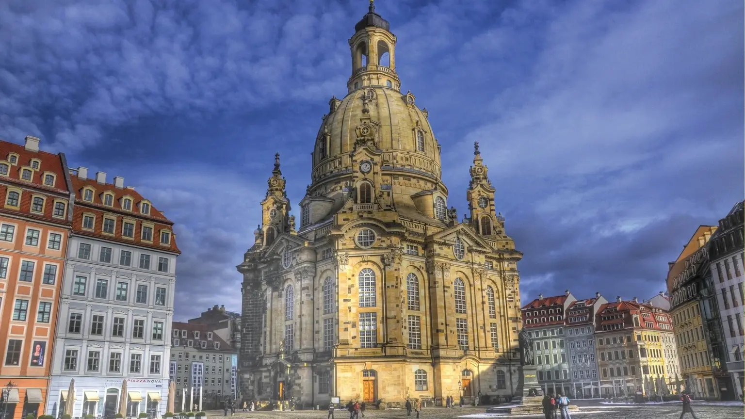 The domed Baroque Frauenkirche rising above Dresden's Neumarkt square, ringed by tall pastel-fronted townhouses