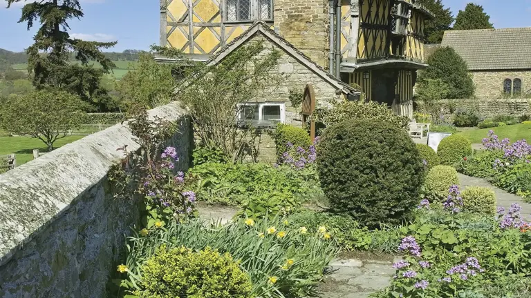 Perfectly preserved medieval fortified manor house with timber-framed gatehouse and crenellated stone tower