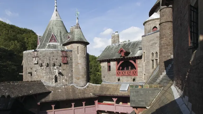 The conical-roofed Victorian Gothic Revival turrets of Castell Coch rising above a beech wood on the hillside north of Cardiff