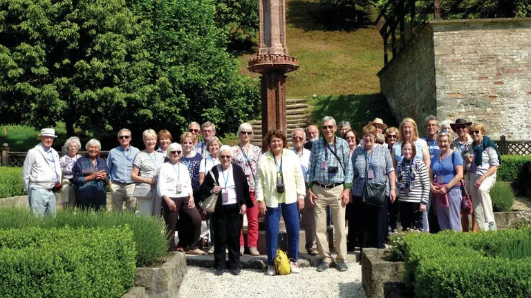 Group of visitors in the gardens of Visegrád Royal Palace, a medieval fortress overlooking the Danube, Hungary.