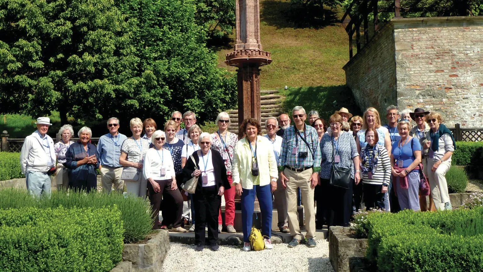Group of visitors in the gardens of Visegrád Royal Palace, a medieval fortress overlooking the Danube, Hungary.