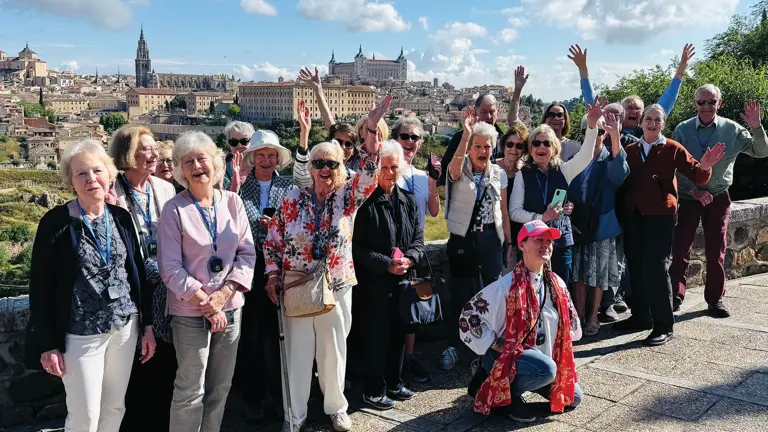 Group of visitors at a viewpoint overlooking Toledo, the historic hilltop city in central Spain with dramatic architectural silhouette.